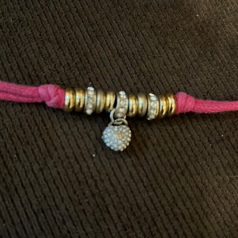 Pink cord and gold juicy couture bracelet with heart charm